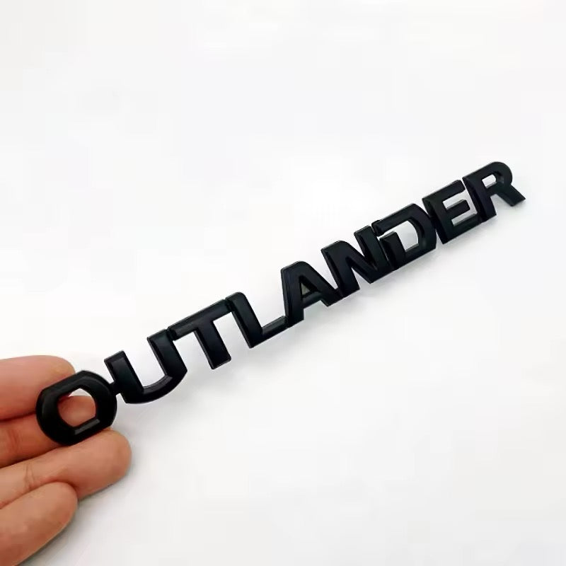Emblema para portón trasero. Mitsubishi Outlander